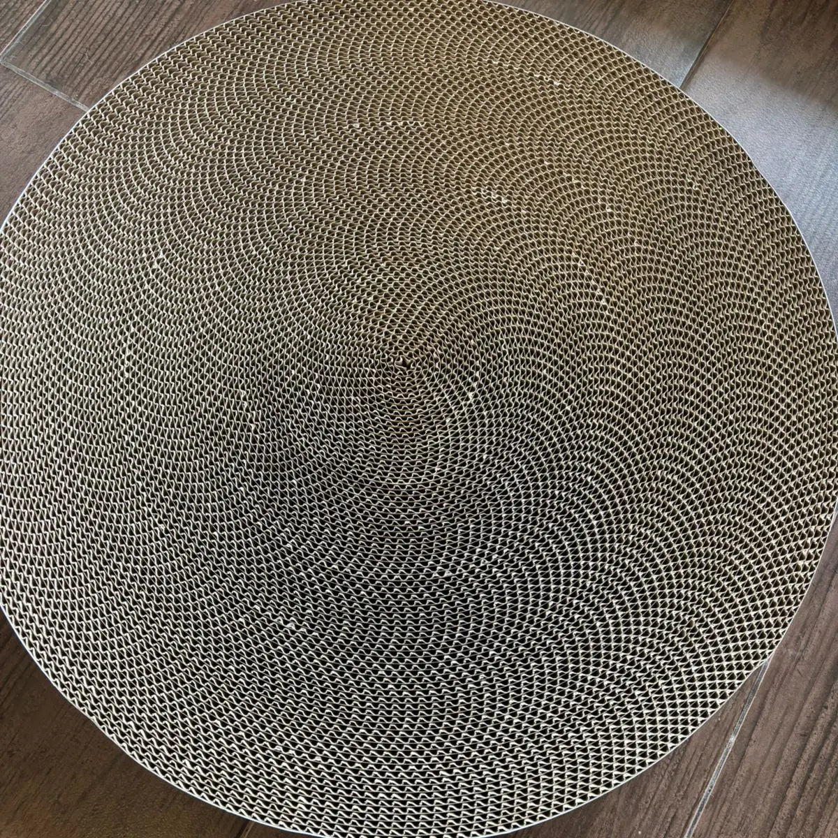 Round woven mat on a wooden floor