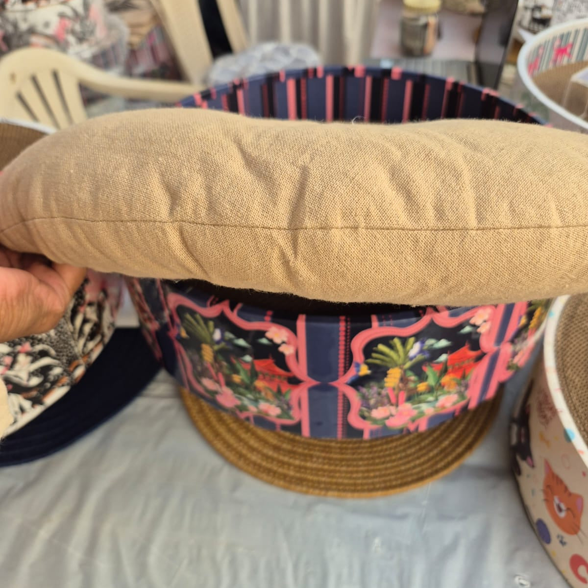 Decorative woven basket with a floral pattern on a table