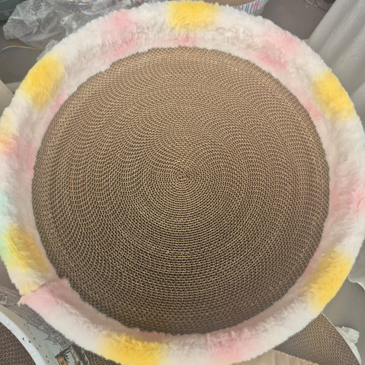 Round woven mat with colorful border on a surface